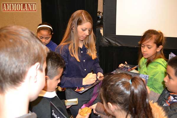 USA Shooting Team Olympic Gold Medalist Jamie Gray signs autographs for school children during the Youth Wildlife Conservation Experience.