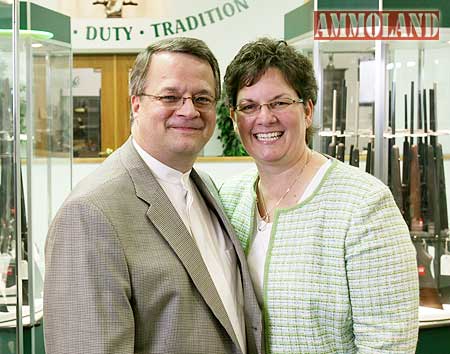 Miles hall poses with his wife at H&H Shooting Sports.