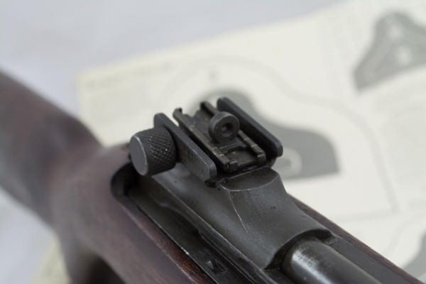 The original rear sight was an "L" type flip sight for dual range. Later, the windage and elevation adjustable aperture sights were phased in.