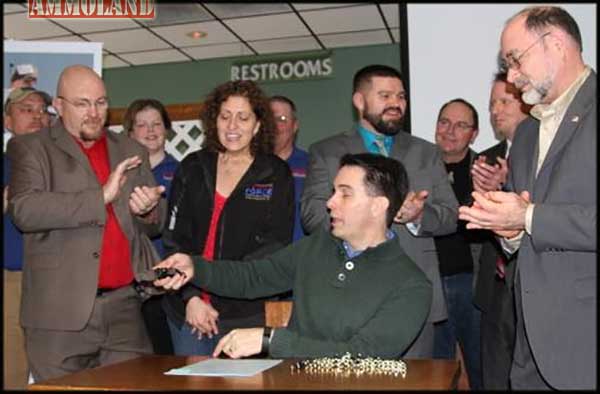 Governor Walker reads the inscription on the specially engraved Pro-Tech TR-4 automatic knife presented to him by Knife Rights Chairman Doug Ritter (right). Wisconsin FORCE Executive Directer Jeff Nass (left) looks on. (Mark LaBarbera photo)