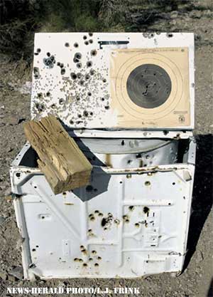 News-Herald Photo/L.J. Frink A discarded washing machine apparently became the perfect target for gun enthusiasts, leaving it riddled with bullet holes. Shell casings can be found laying all over the ground.