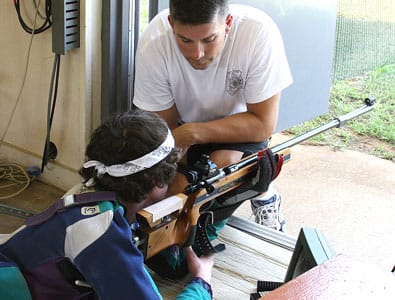 FORT BENNING, Ga.--Jordan Turiano, 16, of Bridgewater, N.J., gets a lesson in steady position from Sgt. 1st Class Jason Parker, U.S. Army Marksmanship Unit, June 23 at Pool International Shooting Complex. Parker and his AMU International Rifle teammates hosted a five-day shooting camp for juniors from all over the country, giving instruction on prone, standing, and kneeling positions, along with an array of other marksmanship techniques. (Photo by Michael Molinaro, USAMU PAO)