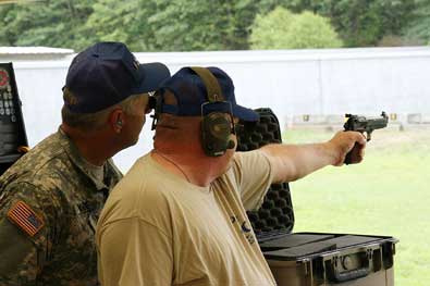 FORT BENNING, Ga.--Staff Sgt. Nathan Wade, South Carolina National Guard, coaches Sgt. 1st Class Mitch Henson, SCNG, during the 50th Interservice Pistol championships held at Fort Benning June 8-12. More than 75 competitors and 14 teams participated in the annual event. (Photo by Michael Molinaro, USAMU PAO)
