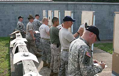 FORT BENNING, Ga.--Marksmen from around the U.S. military check out their targets during the center fire individual match June 10 at Phillips Range on Fort Benning. The match was part of the 50th Interservice Pistol Championships, which brought the best shooters the military has to offer for a week of friendly competition and sharing of ideas. (Photo by Michael Molinaro, USAMU PAO)