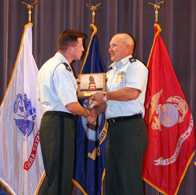 CAMP PERRY, Ohio--Lt. Col. Daniel Hodne, commander, U.S. Army Marksmanship Unit, presents the General Mellon Trophy as the top pistol shooter in the Army to Sgt. 1st Class James Henderson, USAMU, July 19. Henderson swept every major award at the National Championship Matches. (Photo by Michael Molinaro, USAMU PAO)