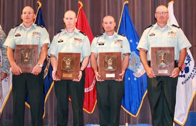 CAMP PERRY, Ohio--The U.S. Army Marksmanship Unit's Blue Team is presented with their plaques for winning the Gold Cup Trophy as the champion in the National Trophy Pistol Team Match July 19 at Camp Perry, Ohio. Team members (from left to right) are Sgt. 1st Class James Henderson, Staff Sgt. John Ennis IV, Staff Sgt. Robert Park II, and Sgt. 1st Class Daryl Szarenski. It was the third straight year that an USAMU team won the prestigious award. (Photo by Michael Molinaro, USAMU PAO)