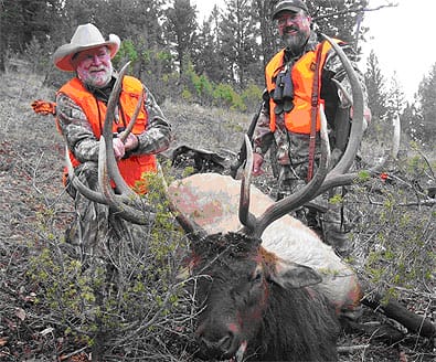 Benelli On Assignment host, Joe Coogan and outdoor writer, John Barsness admire a mature Montana bull elk      taken with Benelli's R-1 rifle on a wilderness hunt in central Montana.