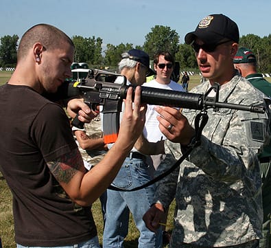 CAMP PERRY, Ohio--Spc. Joseph Hein, U.S. Army Marksmanship Unit, instructs a student on the intricacies of the M16A2 rifle during the Small Arms Firing School Aug. 1. Soldiers from the USAMU instructed novice shooters on how to properly fire a pistol or rifle. (Photo by Michael Molinaro, USAMU PAO)