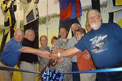 A ribbon cutting ceremony was held at Noon during the Open House to commemorate the new Antolik Mural. In attendance was (left to right) Gary Anderson, Director of Civilian Marksmanship, Orest Michaels, CMP Chief Operating Officer, COL Barb Herrington-Clemens, Garrison Commander, COL Dean Brown, Camp Perry Commander, Jerry Antolik and his wife, Sherry, Gino Barna, Wildlife Supervisor, ODNR, and Ralph Reichman, President, Friends of Camp Perry. 