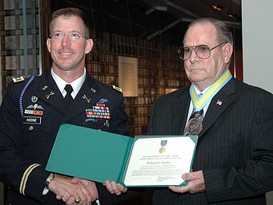 FORT BENNING, Ga.--Lt. Col. Daniel Hodne, commander, U.S. Army Marksmanship Unit, presents William O. Harden with the Meritorious Civilian Service Award Sept. 11 at the National Infantry Museum. Harden was honored by the Soldiers and civilians of the USAMU along with numerous guests for his 52 years of service to the country.  (Photo by Ray Arredondo)