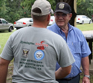 FORT BENNING, Ga.--William O. Harden (right) shakes hands with outgoing Sgt. Maj. Thomas Fuller, U.S. Army Marksmanship Unit, at a unit picnic in August. Harden retired from civilian service after 52 years of military and civilian service to the U.S. (Photo by Michael Molinaro, USAMU PAO)