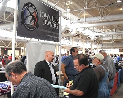 State Representative Kent Sorenson (R-74) (Left, in suit) and IGO's Executive Director Aaron Dorr (Right) explaining the REAL Right-to-Carry bill to 2nd Amendment supporters at the gun show.  