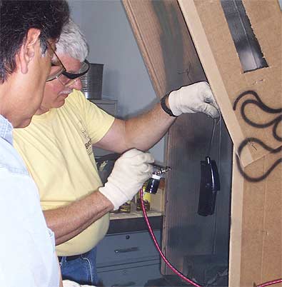 Monty Crain (right) one of Brownells GunTechs demonstrates an alternative finish technique to a gunsmithing school student