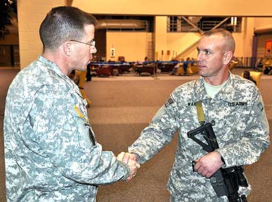 FORT BENNING, Ga. -- LTC Daniel Hodne, commander, U.S. Army Marksmanship Unit, talks with one of his Soldiers moments before Soldiers from the USAMU boarded a plane headed for Kuwait. USAMU Soldiers have deployed to Afghanistan for the first time since the beginning of Operation Enduring Freedom, and will instruct Afghan security forces on marksmanship fundamentals. 