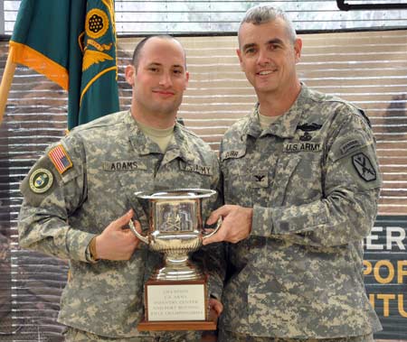 FORT BENNING, Ga.--Col. Charles Durr, Maneuver Center of Excellence chief of staff, presents the Commanding Generals trophy to the overall champion of the 2010 Fort Benning MCOE Rifle match, Cadet Sean-Paul Adams, N. Georgia College and State University. Adams also took home the top prize in the pistol match. (Photo by Michael Molinaro, USAMU PAO)