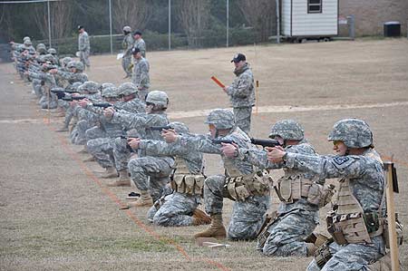 FORT BENNING, Ga.--Soldiers and Cadets fire shots downrange Feb. 4 at Parks Range during the 2010 Fort Benning Post Pistol Championships. Although the final day produced heavy rains, the competitors managed to have a good time at the range. (Photo by Michael Molinaro, USAMU PAO)