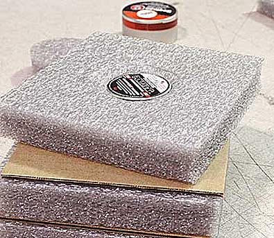 The pellets are packed foam with tin, cardboard square, foam with tin, cardboard square until the entire order is packed and the stack goes into a box.