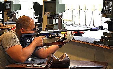 FORT BENNING, Ga.--Capt. Juan Guerrero, Company C, Warrior Transition Battalion, Fort Sam Houston, Texas, trains Mar. 30 inside Pool Indoor Range. Guerrero, who suffered severe injuries to both legs while deployed to Iraq in 2007, is training with Soldiers from the U.S. Army Marksmanship Unit on the air rifle in preparation for the inaugural Warrior Games that will be held May 10-14 at the Olympic Training Center in Colorado Springs, Colo. (Photo by Michael Molinaro, USAMU PAO)