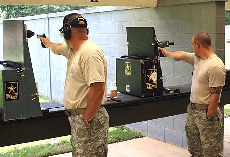 FORT BENNING, Ga.-- Sgt. 1st Class James Henderson (left) and Staff Sgt. Robert Park II (right), U.S. Army Marksmanship Unit, compete in the 2009 Interservice Pistol Championship. Henderson was the overall individual champion, edging out his Army teammate Park. The 2010 Interservice Pistol championships are scheduled for June 11-18 at Fort Benning. (Photo by Michael Molinaro, USAMU PAO)