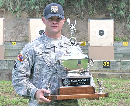 FORT BENNING, Ga.--Sgt. Patrick Franks, U.S. Army Marksmanship Unit, stands with the Marine Corps Trophy after winning the individual .45-cal championship at the 51st Interservice Pistol Championship June 16. (Photo by Mike Badger)