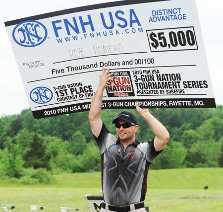 Robert Romero, winner of the FNH USA 3-Gun Nation Shoot-off, happily accepts a check for $5,000.