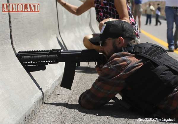 Protester Eric Parker from central Idaho aims his weapon from a bridge next to the Bureau of Land Management's base camp.