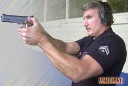 Chief of the LAPD, Charlie Beck, with a 1911 pistol