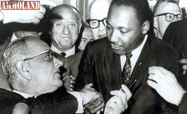 President Lyndon Johnson shakes hands with the Reverend Martin Luther King, Jr., after handing him one of the pens used in signing the Civil Rights Act of July 2, 1964 at the White House in Washington.