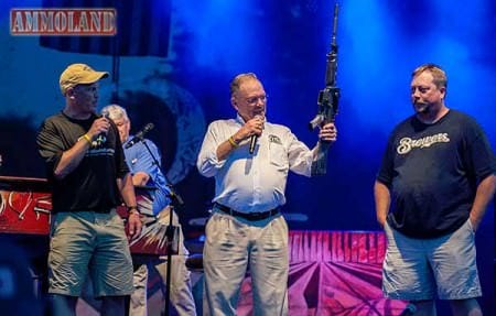 Photo Caption: Frank Brownell (middle) admires his custom AR-15 while sons Pete (left) and Bob (right) look on.