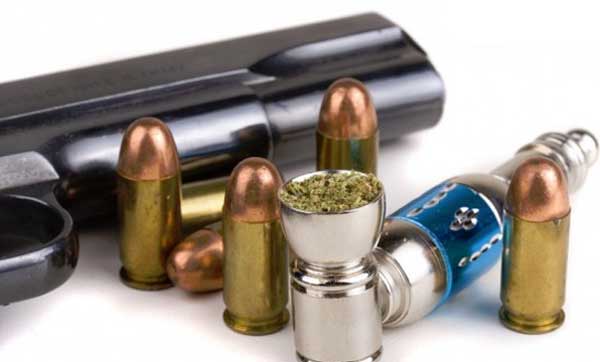 Marijuana and Guns Gun bullets and drugs on a white background shutterstock 12809797