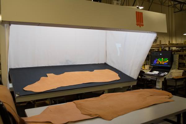 High-tech cutting. The leather is optically scanned to capture shape and flag areas of imperfection.