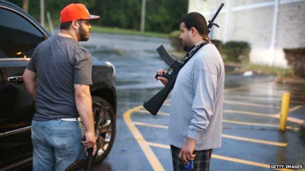 Business owners carry so called "assault weapons" to protect their stores from looters in Ferguson, Missouri 