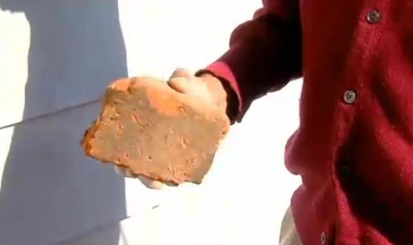 The police said the suspect was unarmed, but Giles left this brick that was used to break the window.