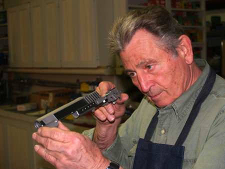 Master Gunsmith Gene Shuey Inspects a Pistol Slide