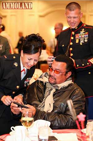 Steven Seagal with Military Woman Looking at Phone
