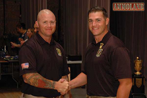 During the awards ceremony, SFC Patrick Franks was given the honor of pinning Ryan with his new Distinguished Service Pistol Badge – earned at Camp Perry. To return the sentiment, Ryan pinned Patrick with his Distinguished .22 Rimfire Pistol Badge, which he earned at Camp Perry as well.