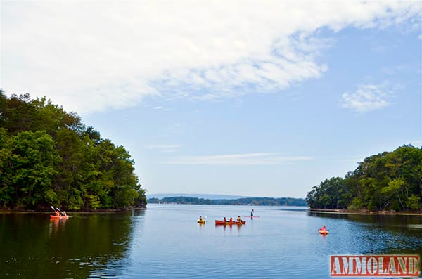 A group of siblings kayaks, canoes and paddle boards together immediately following the boat shed dedication at Harrison Bay State Park. The children and their mother, Stephanie Pyles, are local residents and frequent park visitors who volunteered to help on the project.