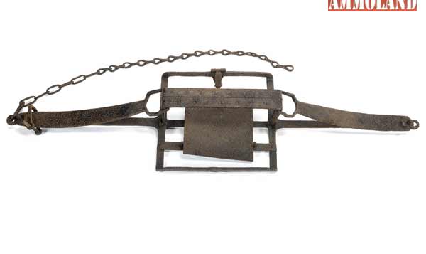 19th century iron mantrap with eighteen-inch jaws and a tilting footplate.