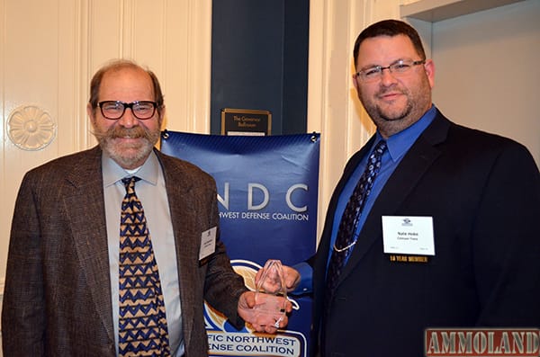 Lew Danielson Crimson Trace Founder (left) and Nate Hoke Crimson Trace Customer Service Director with PNDC award