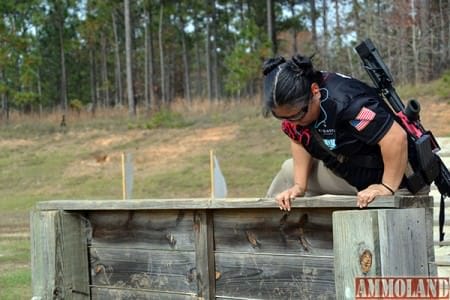 A competitor climbs over a wall on Stage 10 and was immediately required to crawl under barbed wire. The 2015 Fort Benning Multi-gun Challenge was held on Krilling Range Dec. 4-6, 2015, hosted by the Directorate of Family and Morale, Welfare and Recreation and built and overseen by the U.S. Army Marksmanship Unit.
