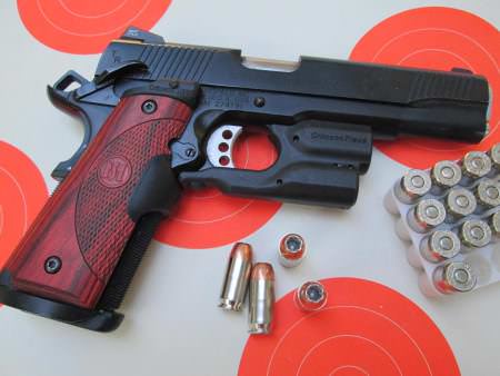 This Springfield Armory 1911 TRP has Crimson Trace Lasergrips and a Crimson Trace Lightguard. Neither one makes this gun any more difficult to carry.