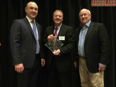 Charles Brown flanked by presenters Evan Huesinkveld (L) of Sportsmen's Alliance and Tommy Millner CEO of Cabelas.