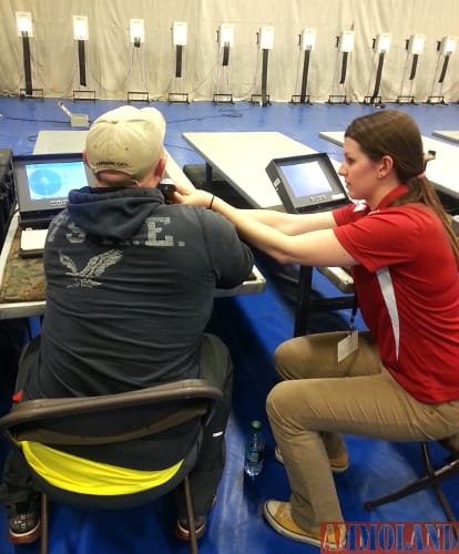 Besides providing the electronic targets, the CMP staff members also aide the athletes with air gun shooting. Ashley Jackson, right, assisted shooters on the line during the Marine Corps Wounded Warrior Trials at Camp Pendleton, Calif. 