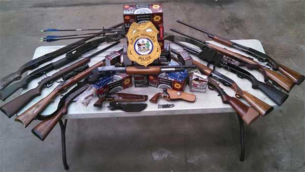 Officers seized as evidence 13 firearms (eight shotguns, two rifles, two black powder revolvers and a muzzleloader rifle), a compound bow and arrows, two knives and an assortment of ammunition. Officers seized as evidence 13 firearms (eight shotguns, two rifles, two black powder revolvers and a muzzleloader rifle), a compound bow and arrows, two knives and an assortment of ammunition.