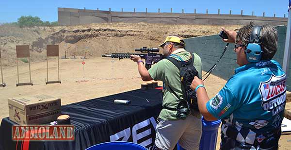 Julie Waasted, of the Lucas Oil shooting team, guides a newcomer through a 3GN Classifier stage.