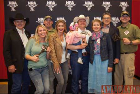 (Left to right) Retired Lt. Gen. Leroy Sisco, Crystal Battiest, former Spc. Frank Battiest, Eva Shockey, Sofiya Arola, former Maj. Andrew Arola, Veronika Arola, Governor Rick Perry, former Sgt. Christopher Gray. Photo Credit: NRA Publications