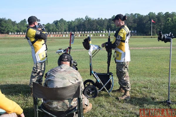 Staff Sgt. Kevin Trickett fires downrange as his teammate Staff Sgt. Amanda Elsenboss waits her turn during the Interservice Rifle Team Championship match at the 55th Interservice Rifle Championship June 27, 2016. Shooting Teams from the Army, Navy, Marine Corps, All Guard and Army Reserve competed in the event June 22-29. (U.S. Army photo by Brenda Rolin/released)