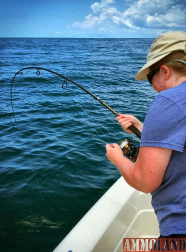 Kim Hill battles an amberjack while fishing with Bobby Dove and Hooligan Charters.