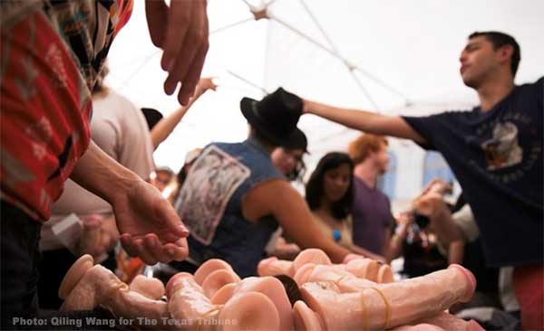 UT-Austin organizers pass out dildos to students for the Cocks Not Glocks movement in protest of newly enacted campus carry law on August 23, 2016. (Photo: Qiling Wang for The Texas Tribune)