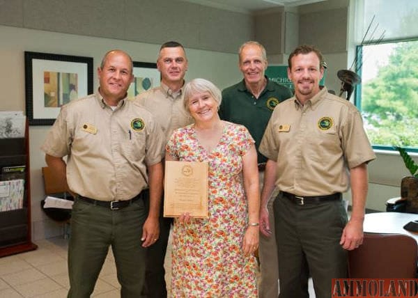 The Michigan Department of Natural Resources recently honored Susan Lackey, recently retired executive director of the Ann Arbor-based Legacy Land Conservancy, with a Partners in Conservation Award. Pictured from the left are Chuck Dennison, Pinckney Recreation Area; Gary Jones, Waterloo Recreation Area; Susan Lackey, recently retired executive director of the Legacy Land Conservancy; Ron Olson, DNR Parks and Recreation Division chief; and Jim O'Brien, Hayes State Park.